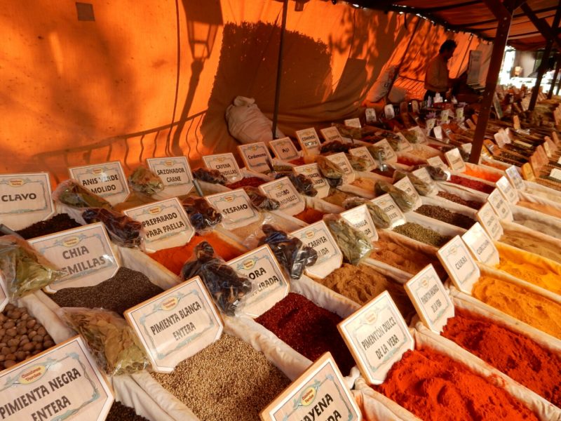 Colourful herbs and spices lined up at market.